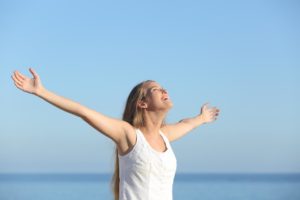 Woman with arms spread in joy and peace